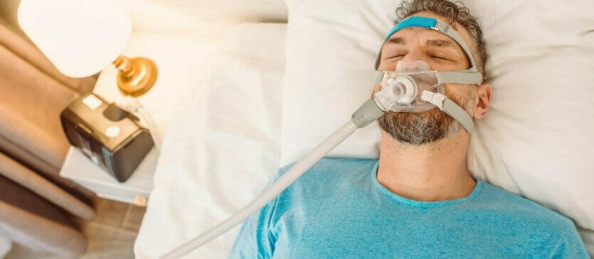A CPAP machine complete with hose and mask.